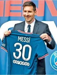  ?? —
AFP ?? Argentina’s star footballer Lionel Messi poses as he holds-up his Number 30 jersey during a press conference at the French football club Paris Saint-Germain’s (PSG) Parc des Princes stadium in Paris on Wednesday.