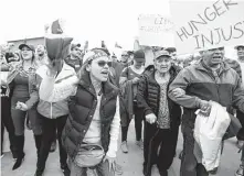  ?? Photos by Karen Warren / Staff photograph­er ?? Venezuelan­s from around Houston rallied in Katy to show support for Juan Guaidó, the acting president recognized by the U.S. Silvia Romero, right, was among the crowd.