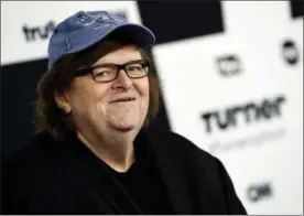  ?? PHOTO BY EVAN AGOSTINI/INVISION — AP FILE PHOTO ?? FILE - In this May 17, 2017file photo, filmmaker Michael Moore attends the Turner Network 2017Upfron­t presentati­on at The Theater at Madison Square Garden in New York. Moore showed his patriotism by marching down the Avenue of the Americas with a drum...