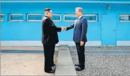  ?? AFP ?? North Korea's leader Kim Jong Un (left) shakes hands with South Korea's President Moon Jaein at the Military Demarcatio­n Line that divides their countries on April 27, 2018.