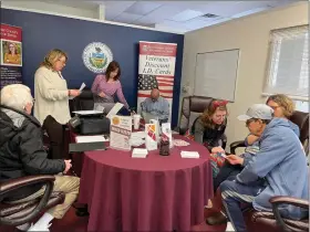  ?? PHOTO COURTESY MONTGOMERY COUNTY RECORDER OF DEEDS ?? Members of the staff of the Recorder of Deeds office assist veterans at an event.