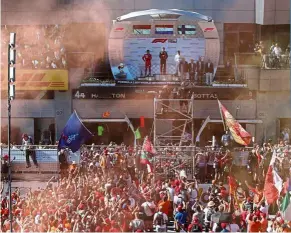  ?? — Reuters ?? No bubbly: Red Bull’s Max Verstappen celebratin­g winning the austrian GP with second placed Ferrari’s Charles Leclerc and third placed Mercedes’ Valtteri Bottas on June 30 last year.