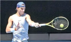  ??  ?? Rafael Nadal of Spain hits a backhand during a practice session, ahead of the Australian Open tennis tournament. - AFP photo