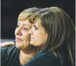  ?? MATT DAHLSEID/ NEW MEXICAN FILE PHOTO ?? Suspended Robertson coach Stacy Fulgenzi, right, embraces acting head coach Fran Jenkins after the Cardinals won the state volleyball title Nov. 17.