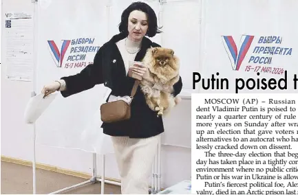  ?? AP ?? A woman holds her pet as she leaves a voting booth during the election in Vladivosto­k, east of Moscow yesterday.