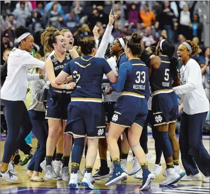  ?? SEAN D. ELLIOT/THE DAY ?? Notre Dame celebrates the win over UConn in NCAA Final Four national semifinal action Friday at the Nationwide Arena in Columbus, Ohio. More coverage, B1.