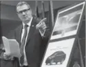  ??  ?? Det. Sgt. Peter Thom shows photos of suspect vehicles in the Angelo Musitano hit.