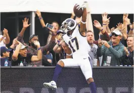  ?? Sean M. Haffey / Getty Images ?? The Rams’ Robert Woods celebrates his 94-yard TD reception from Jared Goff by jumping into the crowd at the Los Angeles Coliseum.