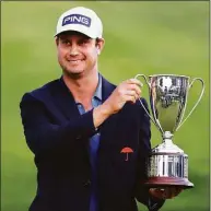  ?? Michael Reaves / Getty Images ?? Harris English poses with the trophy after winning the Travelers Championsh­ip on the eighth playoff hole at TPC River Highlands in June.