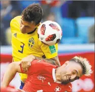  ?? Efrem Lukatsky / Associated Press ?? Sweden’s Victor Lindelof, left, heads for the ball with Switzerlan­d’s Granit Xhaka during Tuesday’s game.