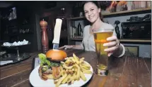  ?? (Kristopher Skinner/bay Area News Group file) ?? Hannah Wackerman serves up a beer to go with the Twisted Burger at the 1850 restaurant.