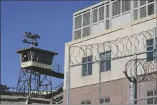  ?? AP PHOTO/ERIC RISBERG ?? Barbed wire and a guard tower is seen at San Quentin State Prison on April 12, 2022, in San Quentin, Calif.