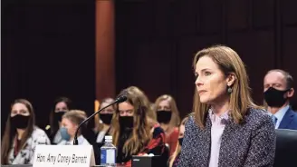  ?? Erin Schaff / Associated Press ?? Supreme Court nominee Amy Coney Barrett listens during her confirmati­on hearing before the Senate Judiciary Committee on Wednesday on Capitol Hill.