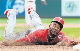  ?? Abbie Parr Getty Images ?? JABARI BLASH is thrown out at first base in the ninth inning en route to another loss by the Angels to the Seattle Mariners at Safeco Field.