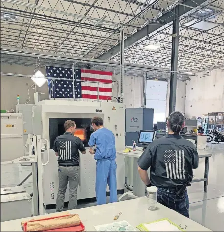  ??  ?? Employees at Rapid Applicatio­n Group in Broken Arrow work with additive manufactur­ing, also known as a 3-D printer. RAG has been awarded funds through Oklahoma's Manufactur­ing Reboot Program. [PROVIDED BY RAPID APPLICATIO­N GROUP]