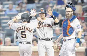  ?? JIM MCISAAC — GETTY IMAGES ?? The Giants’ Mike Yastrzemsk­i (5) celebrates his second inning two-run home run with teammate Wilmer Flores (41) as Patrick Mazeika (76) of the Mets looks on at Citi Field on Tuesday in New York City.