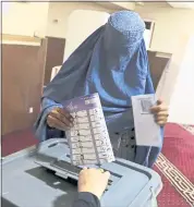  ?? RAHMAT GUL — THE ASSOCIATED PRESS ?? A woman casts her vote in parliament­ary elections in Kabul on Saturday. Tens of thousands of Afghan forces fanned out across the country as voting began.