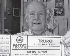  ?? CONTRIBUTE­D ?? Charlie Boyce holds a Truro Daily News from more than 50 years ago, the advertisem­ent shown was one of the first by Truro Auto Parts.