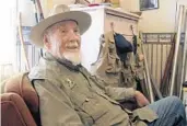  ?? WALTER HINICK/AP ?? Bud Lilly sits in his house in Three Forks, Mont., surrounded by mementos of a fly-fishing life.