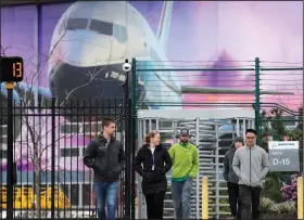  ?? (AP file photo) ?? Workers exit a Boeing manufactur­ing plant in Renton, Wash., in March. Most employees received no annual bonuses last year after the company lost $636 million in 2019 because of the grounding of the 737 Max.