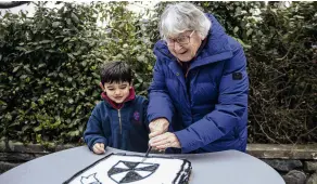  ?? ?? Let them eat cake . . . Cutting the cake are Robbie Apolosi, 5, who is at least the fourth generation in his family to attend the school, and Marney Inder, 91, who attended the school in 1937.
