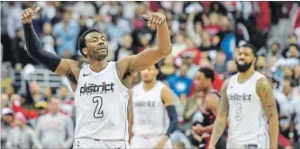  ?? JONATHAN NEWTON THE WASHINGTON POST ?? Washington Wizards guard John Wall celebrates at the end of their win over the Toronto Raptors on Sunday.