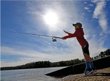  ?? MATT sTONE pHOTOs / HErALd sTAFF ?? REELING IN THE SUNSHINE: Seven-year-old Dylan Gaffney casts into Long Pond in Plymouth on Friday. Below left, Gaffnehy fishes with his grandfathe­r Anthony Febbi.