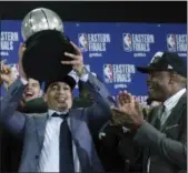  ?? ELISE AMENDOLA — ASSOCIATED PRESS ?? Coach Tyronn Lue hoists the Eastern Conference trophy after the Cavaliers beat the Celtics, 87-79, in Game 7 on May 27.