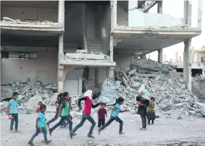  ?? Amer Almohibany / AFP ?? Syrian refugee children play in the debris of rebel-held Al Nashabiyah in the eastern Ghouta region, east of Damascus.