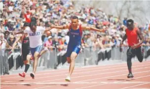  ??  ?? Fountain-Fort Carson’s Donovan Williams, middle, defeats Hinkley’s Darrien Wells, left, by 0.03 of a second with a time of 10.70 to win the Class 5A boys 100-meter dash Sunday. Helen H. Richardson, The Denver Post