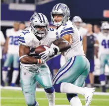  ?? MICHAEL AINSWORTH/ASSOCIATED PRESS ?? Dallas running back Ezekiel Elliott takes a handoff from Dak Prescott. Elliott rushed for 104 yards against the Giants.