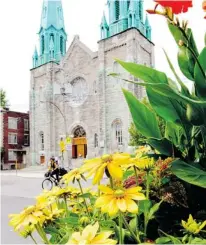  ??  ?? Colourful flowers frame Ste. Cecile Church at 7380 Henri-Julien Ave.