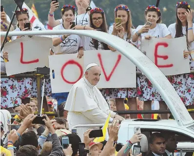  ?? AP PHOTO ?? MESSAGE: Faithful participat­ing in the World Youth Days greet Pope Francis as he rides through the crowd in Krakow, Poland, yesterday as part of his five-day visit.
