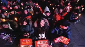  ??  ?? SEOUL: Protesters attend a candle-lit rally calling for South Korean President Park Geun-Hye’s immediate departure from her office. — AFP