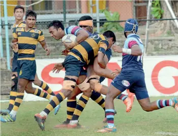  ??  ?? Antonian playmaker Jehan Seelaratne is brought down by the Royal defence - Pic by M.D. Nissanaka