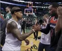  ?? CHARLES KRUPA — THE ASSOCIATED PRESS ?? Celtics guard Isaiah Thomas, left, and Wizards guard John Wall speak on the court after Monday’s game.