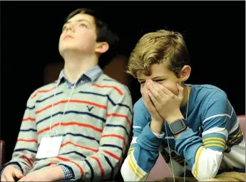  ?? ANDY SHUPE NWA DEMOCRAT-GAZETTE ?? Weston Sills, right, of Lynch Middle School in Farmington, reacts as the field is narrowed during the Washington County Spelling Bee. Weston won the bee.