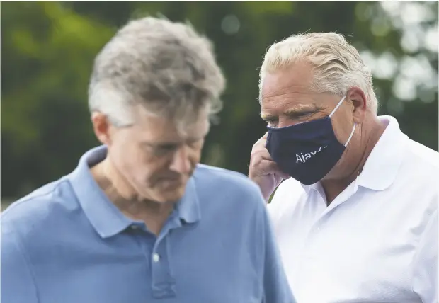  ?? Chris Young / The Canadian Pres Files ?? Ontario Premier Doug Ford, pictured with Finance Minister Rod Phillips in July, is expected on Thursday to present the province’s first budget since the start of the pandemic. The Progressiv­e Conservati­ve government postponed delivering a full fiscal plan earlier this year.