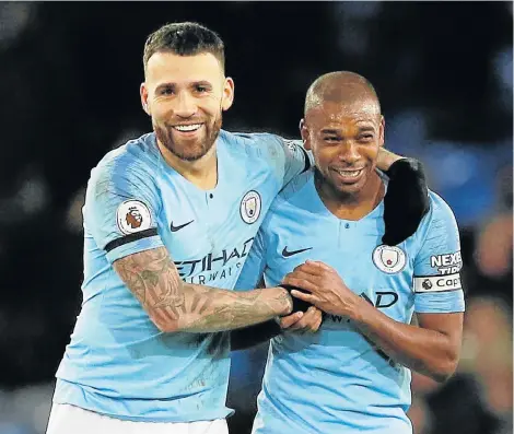  ?? Picture: REUTERS ?? TOP DOGS: Manchester City’s Nicolas Otamendi and Fernandinh­o celebrate the team’s victory over Everton on Wednesday