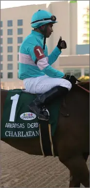  ?? (Arkansas Democrat-Gazette/Thomas Metthe) ?? Jockey Martin Garcia gives a thumbs up to celebrate Charlatan’s victory in the first leg of the Arkansas Derby on Saturday.