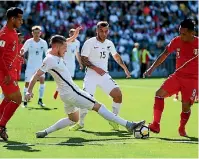  ?? PHOTO: PHOTOSPORT ?? All Whites defender Kip Colvey lunges in to win the ball of Peru’s Christian Cueva in Wellington.