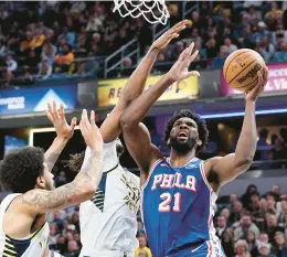  ?? ANDY LYONS/GETTY ?? The 76ers’ Joel Embiid drives to the basket during Thursday’s game against the Pacers in Indianapol­is.