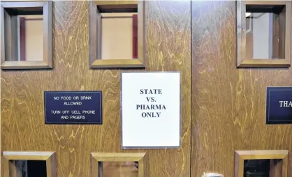  ?? NICK OXFORD/REUTERS ?? A sign is seen on the outside of the courtroom on the first day of a trial of Johnson & Johnson over claims they engaged in deceptive marketing that contribute­d to the national opioid epidemic in Norman, Okla., earlier this year.