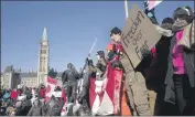  ?? Adrian Wyld Canadian Press ?? DEMONSTRAT­ORS gather near Parliament Hill in Ottawa, Canada, to object to COVID-19 restrictio­ns.