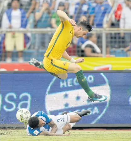  ??  ?? Australia’s Tomi Juric jumps over Honduras’ Henry Figueroa at the Olympic Stadium in San Pedro Sula.