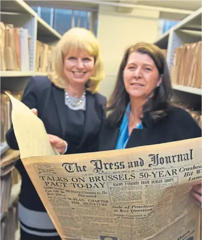  ??  ?? READ ALL ABOUT IT: Fiona Clark, left, and Marie Boulton with a vintage copy of The Press and Journal