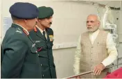  ?? — PTI ?? Prime Minister Narendra Modi with Army Chief Gen. Dalbir Singh and the head of a medical team at the Army’s Research & Referral Hospital, where Lance Naik Hanumantha­ppa is being treated, in New Delhi on Tuesday.