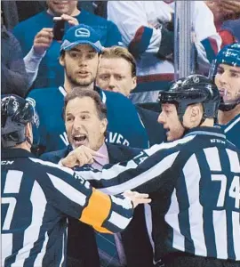  ?? Jonathan Hayward Associated Press ?? VANCOUVER CANUCKS Coach John Tortorella has been suspended 15 days for trying to enter the Calgary Flames’ locker room between periods Saturday.