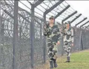  ?? AP ?? Border Security Force personnel patrol past a fence on the IndiaBangl­adesh border at Assam.