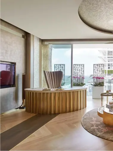  ??  ?? LEFT TO RIGHT Grey oak floor panels draws the eye towards views from the balcony; the curved wall in the kitchen adds to the home’s feminine appeal; the oyster pink ceiling and the plum blossom mural enliven the window-less corridor